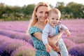 Happy mother and her little son phaving fun in a lavender field Royalty Free Stock Photo