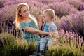 Happy mother and her little son phaving fun in a lavender field Royalty Free Stock Photo