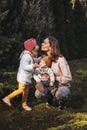 Happy mother and her son and doughter on nature smiling, play and embracing. Love and tenderness. International hugging day Royalty Free Stock Photo