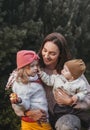 Happy mother and her son and doughter on nature smiling, play and embracing. Love and tenderness. International hugging day Royalty Free Stock Photo