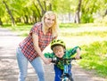 Happy mother with her son having fun, riding a bicycle Royalty Free Stock Photo