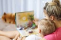 Happy mother and her son read a book together Royalty Free Stock Photo