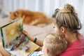 Happy mother and her son read a book together Royalty Free Stock Photo