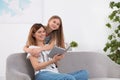 Happy mother and her teenage daughter with book Royalty Free Stock Photo