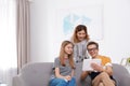 Happy mother, her teenager daughter and son with tablet Royalty Free Stock Photo