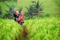 Happy mother hold little baby in hiking backpack carrier