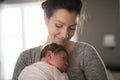 Happy mother holding adorable child baby on the living room Royalty Free Stock Photo