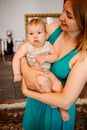 Mother Holding Baby Calming Her Newborn Child Mom Gently Soothing Infant. Five month old baby with blue eyes. Royalty Free Stock Photo