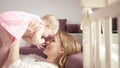 Happy mother holding baby in hands. Adorable little girl with mom enjoy life Royalty Free Stock Photo