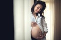 Happy mother holding hands on baby bump, pregnant belly. portrait of beautiful pregnant woman being happy Royalty Free Stock Photo