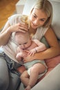 Happy mother holding her little baby boy in arms at home. Royalty Free Stock Photo