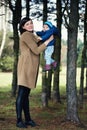 Happy mother holding her little son in her arms in the park. girl and little boy in the forest. Royalty Free Stock Photo