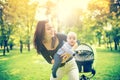 Happy mother holding and playing with newborn son. Happy woman holding infant, little kid and child Royalty Free Stock Photo