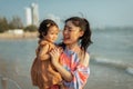 happy mother holding and talking toddler baby girl on sea beach Royalty Free Stock Photo