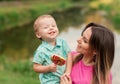 Happy mother holds cute smiling son outdoors Royalty Free Stock Photo