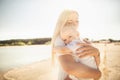 Happy mother huges baby. Mother holds child in her arms, baby hugging mom, close-up Royalty Free Stock Photo