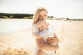 Happy mother huges baby. Mother holds child in her arms, baby hugging mom, close-up Royalty Free Stock Photo