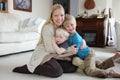 Happy Mother Hugging her Two Young Children at Home Royalty Free Stock Photo