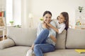 Happy mother hugging together and having fun with her teenage daughter at home on weekend. Royalty Free Stock Photo