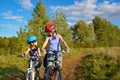 Happy mother and kid on bikes cycling outdoors in park, mother and little daughter having fun on bicycles, active family sport Royalty Free Stock Photo