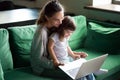 Happy mother with kid daughter having fun online with laptop Royalty Free Stock Photo