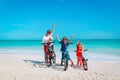 Happy mother with kids biking at beach Royalty Free Stock Photo