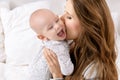 Happy mother kissing her adorable baby son. Happy family. Mother and newborn child playing. Royalty Free Stock Photo