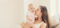Happy mother kissing her little baby in room at home Royalty Free Stock Photo