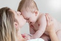 Happy mother kissing 9 months old baby in head Royalty Free Stock Photo