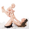 Happy mother lifting her adorable baby son in the air. Happy family. Mother and newborn child portrait. Royalty Free Stock Photo