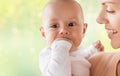 Happy mother with little baby boy sucking fingers Royalty Free Stock Photo