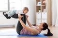 Happy mother with little baby exercising at home Royalty Free Stock Photo