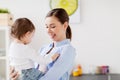 Happy mother and little baby girl at home kitchen Royalty Free Stock Photo