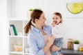 Happy mother and little baby girl at home kitchen Royalty Free Stock Photo