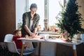 Happy mother and little baby toddler girl making christmas cookies in home kitchen. Mother and little girl baking Royalty Free Stock Photo