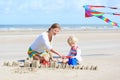 Happy mother and little child playing on the beach Royalty Free Stock Photo