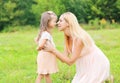 Happy mother and little daughter child in summer day