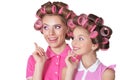 Happy mother and little daughter with hair curlers isolated on white background Royalty Free Stock Photo