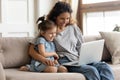 Happy mother with little daughter have fun online use laptop Royalty Free Stock Photo