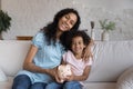 Happy mother and little daughter holding ceramic piggy bank Royalty Free Stock Photo