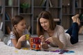 Happy mother and little daughter kid enjoying play