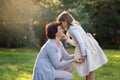 Happy mother and little daughter looking at each other, little girl holding mother`s cheek, mother`s day concept Royalty Free Stock Photo