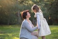 Happy mother and little daughter looking at each other, mother holding little girl, mother`s day concept Royalty Free Stock Photo