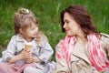 Happy Mother and little Daughter outdoor portrait. Mom and her child enjoying nature together in green park, kissing and hugging, Royalty Free Stock Photo