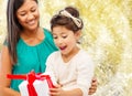 Happy mother and little girl with gift box Royalty Free Stock Photo