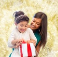 Happy mother and little girl with gift box Royalty Free Stock Photo