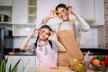 Happy Mother and little girl preparing the vegetables and fruit in kitchen at home. Healthy food Royalty Free Stock Photo