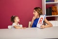 Happy mother with little kid studying together. Preschool studying concept.