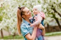 Happy mother with long hair plays with baby