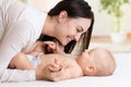 Happy mother looking at baby in bedroom Royalty Free Stock Photo